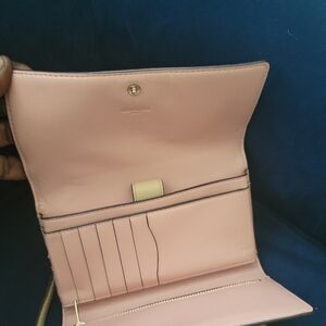 Coach crossbody wallet has small peeling on side 2018